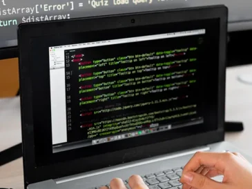 Beginner learning to code on a laptop with AI tutor tool