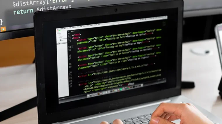 Beginner learning to code on a laptop with AI tutor tool