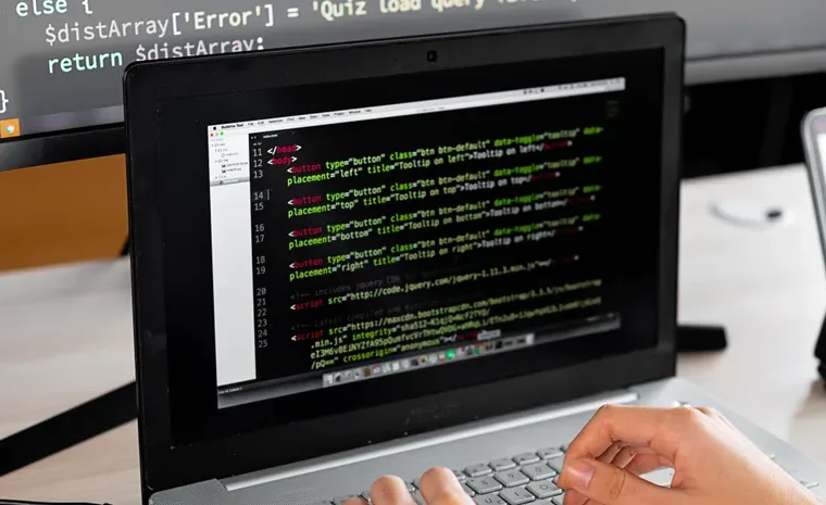 Beginner learning to code on a laptop with AI tutor tool