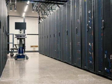 Modern data center corridor with server racks representing cloud technology