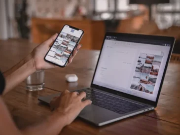 Woman planning social media content on a laptop and smartphone