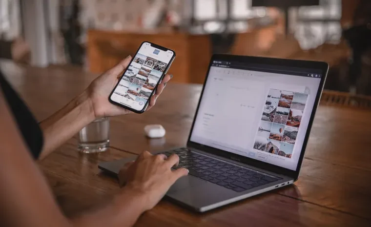 Woman planning social media content on a laptop and smartphone