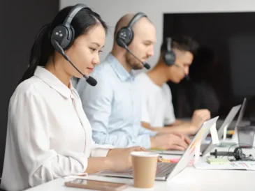 Small business customer support agent using an AI chatbot tool on a laptop