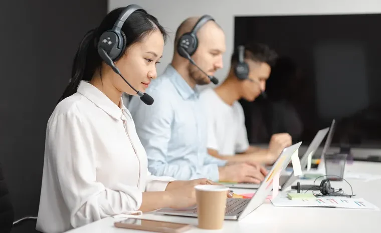 Small business customer support agent using an AI chatbot tool on a laptop