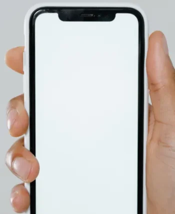 Hand holding an iPhone showing AI features in use