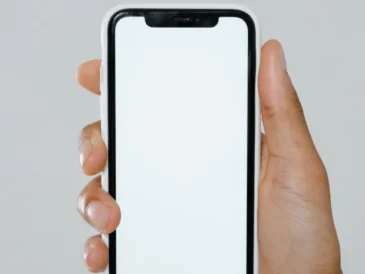 Hand holding an iPhone showing AI features in use