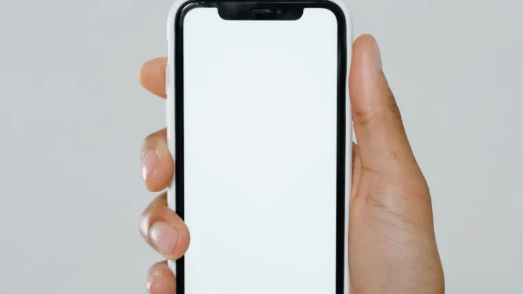 Hand holding an iPhone showing AI features in use