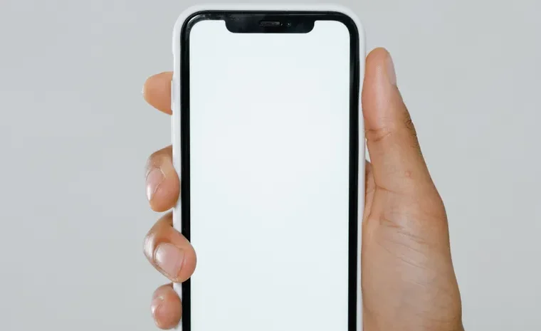 Hand holding an iPhone showing AI features in use