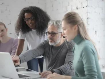 Person editing a document on a laptop with grammar suggestions
