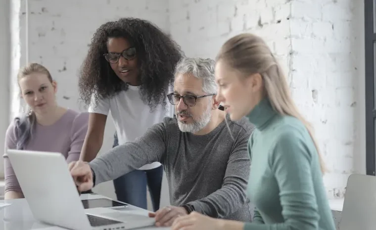 Person editing a document on a laptop with grammar suggestions