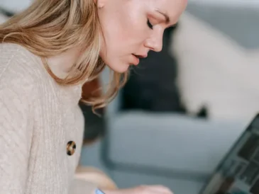 Student taking notes with a laptop for study and research