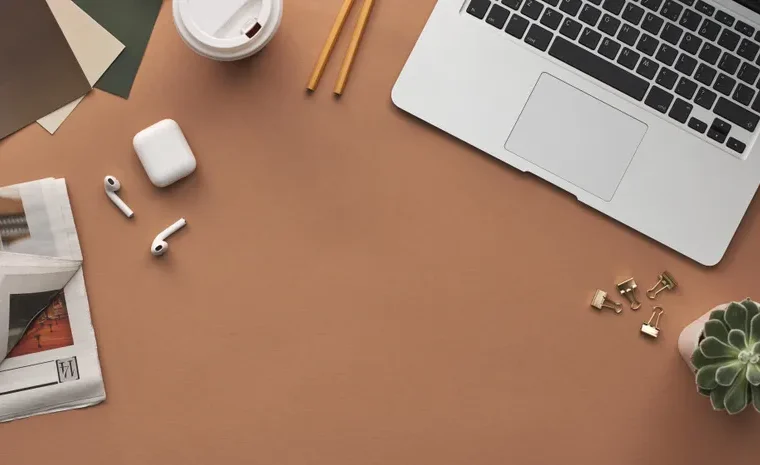Laptop and desk workspace for building a resume with an AI tool