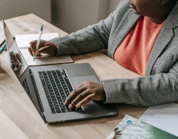 Person typing an email on a laptop using ChatGPT prompts