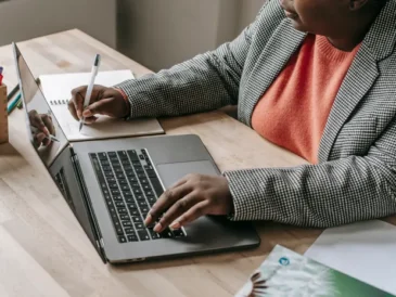 Person typing an email on a laptop using ChatGPT prompts